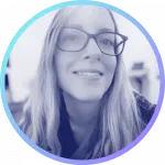 Smiling blonde woman wearing glasses.