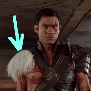 Screenshot of Sab Than from John Carter, with an arrow pointing to the white fur on his shoulder.